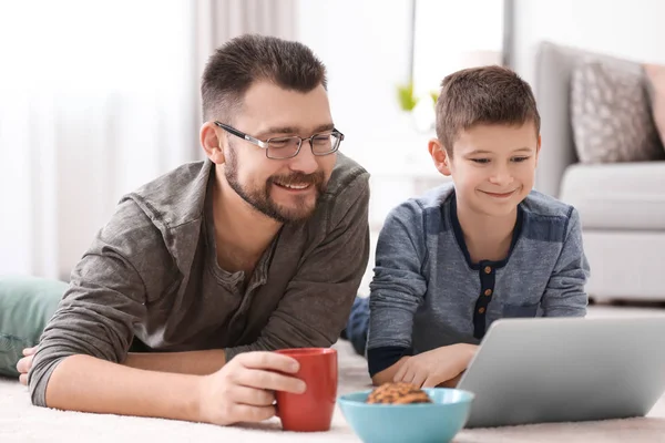 Kleine jongen en zijn papa thuis met behulp van laptop — Stockfoto