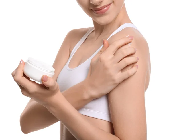 Young woman with jar of body cream on white background — Stock Photo, Image