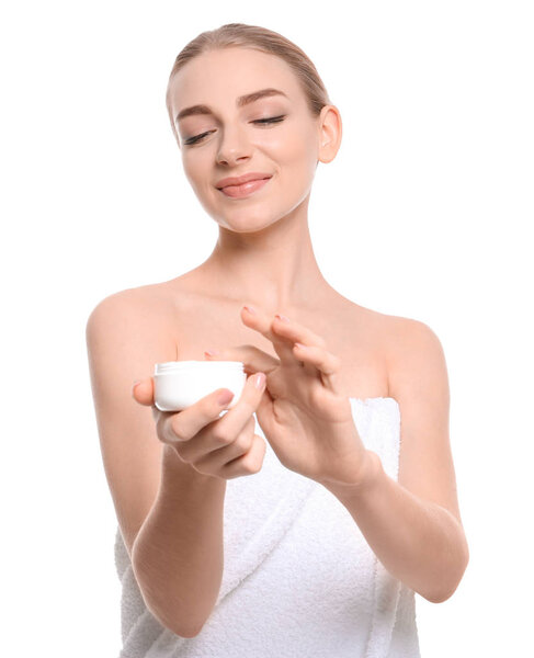 Young woman with jar of body cream on white background