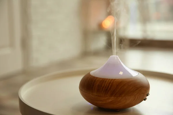 Aroma oil diffuser on table indoors — Stock Photo, Image