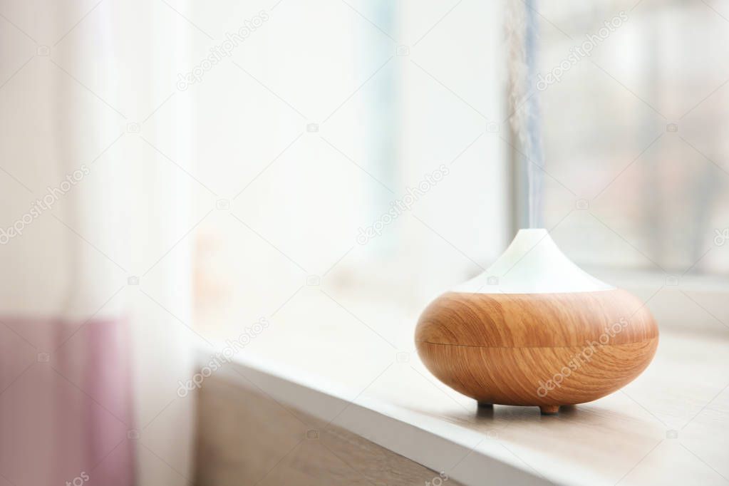 Aroma oil diffuser on window sill