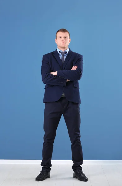 Business trainer standing on color wall background