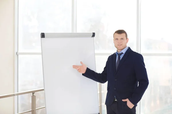 Entrenador de negocios dando presentación en el tablero del rotafolio en interiores —  Fotos de Stock