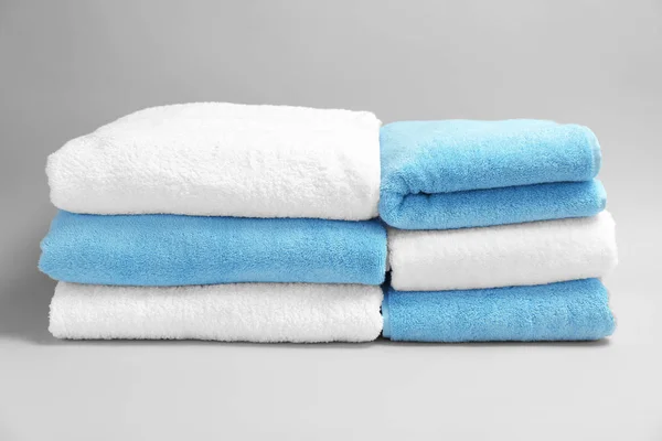 Soft bath towels on grey background — Stock Photo, Image