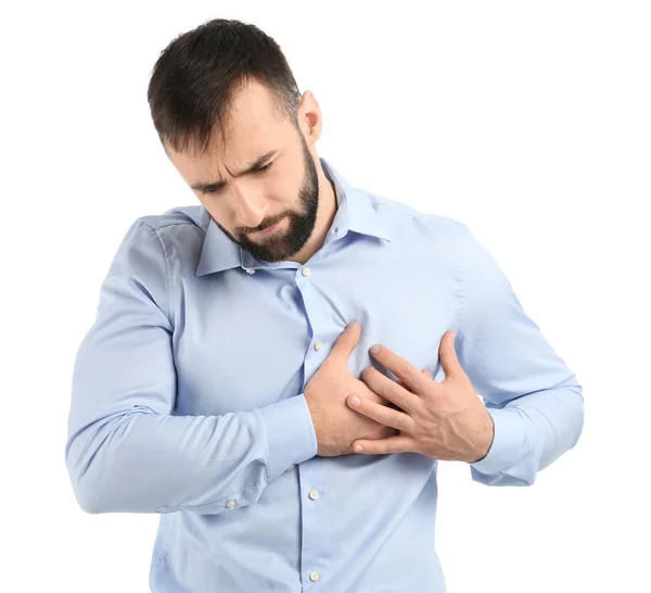 Young man suffering from chest pain on white background — Stock Photo, Image