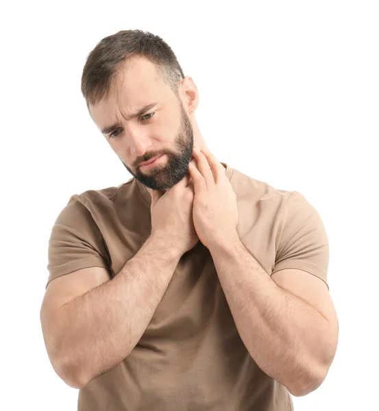 Ung man lider av ont i halsen på vit bakgrund — Stockfoto