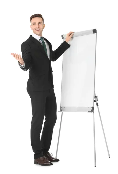 Treinador de negócios jovem perto de flip chart no fundo branco — Fotografia de Stock