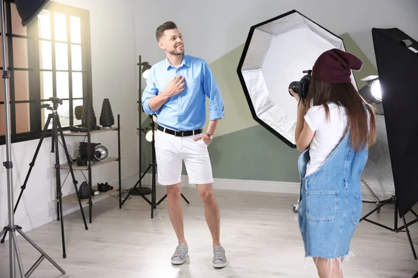 Handsome model posing for professional photographer in studio — Stock Photo, Image