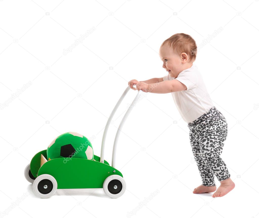 Cute baby with toy walker on white background