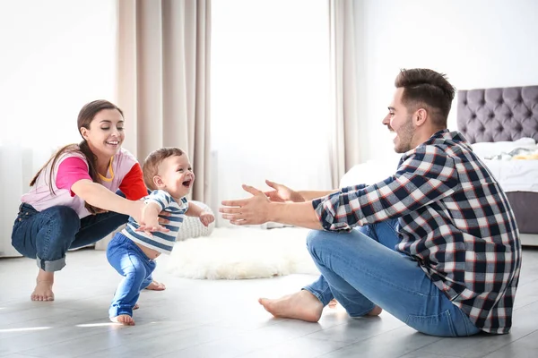 Lycklig familj spelar och barn lära sig gå hemma — Stockfoto