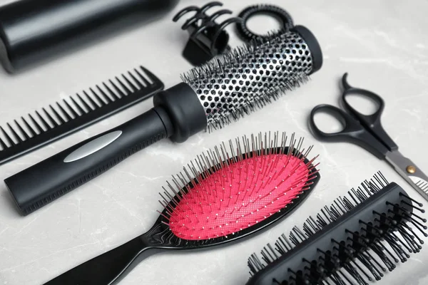 Professional hairdresser tools on grey background