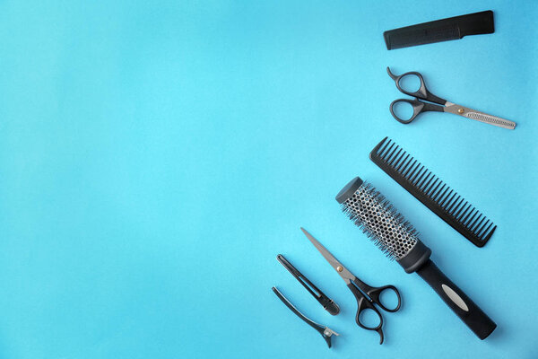 Flat lay composition with professional hairdresser tools on color background