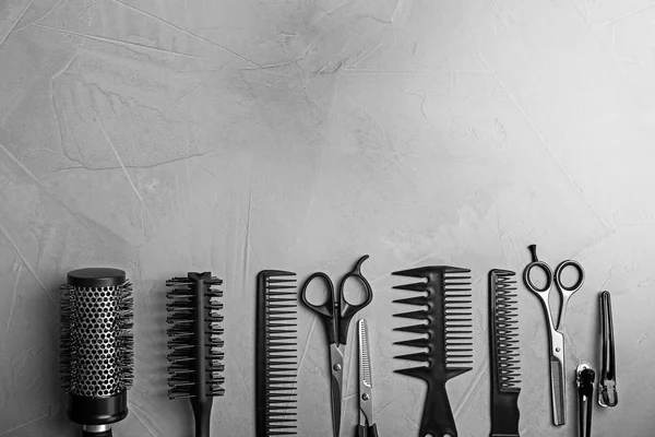 Composición plana con herramientas profesionales de peluquería sobre fondo gris —  Fotos de Stock