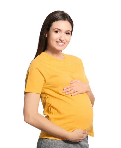 Jeune femme enceinte en vêtements décontractés sur fond blanc — Photo