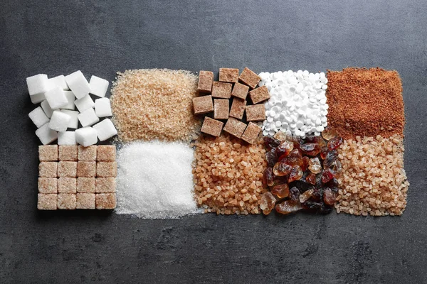 Flat lay composition with different types of sugar on gray background — Stock Photo, Image