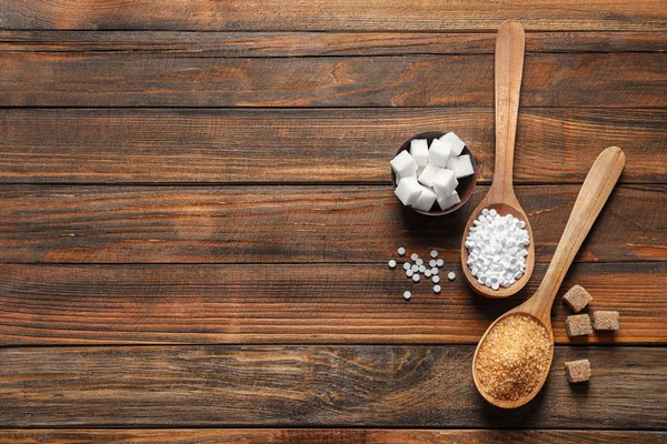 Flat lay composition with different types of sugar on wooden table — Stock Photo, Image