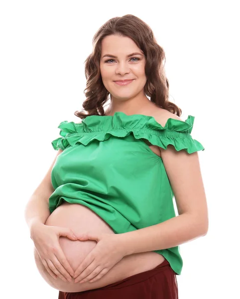 Unga gravid kvinna i casual kläder på vit bakgrund — Stockfoto