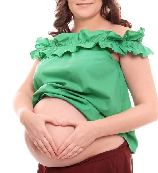 Молода вагітна жінка в повсякденному одязі на білому тлі — стокове фото
