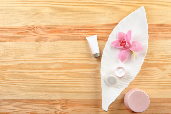 Flat lay composition with body care cosmetics on wooden background — Stock Photo, Image