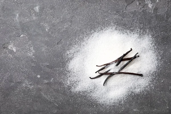 Gri arka plan, üstten görünüm üzerine vanilya şekeri yığını — Stok fotoğraf