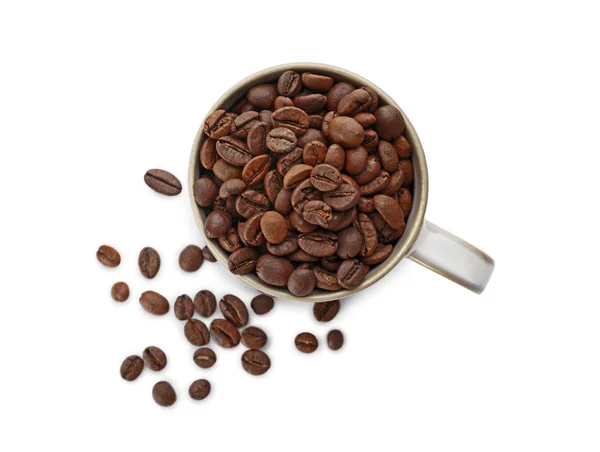 Cup and coffee beans on white background, top view — Stock Photo, Image