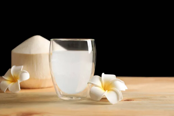 Vidrio con agua de coco fresca sobre mesa de madera — Foto de Stock