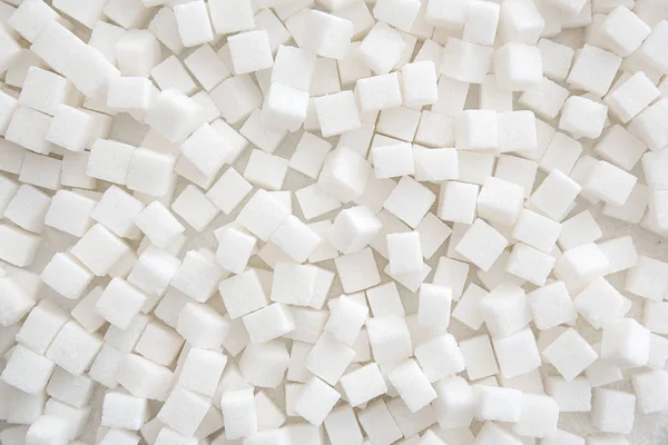 Cubos de azúcar refinados como fondo, vista superior — Foto de Stock
