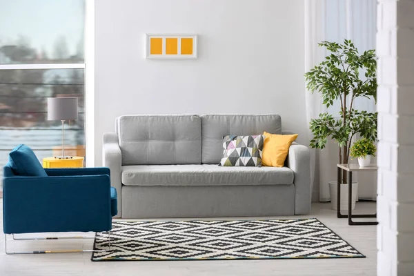 Stylish living room interior with comfortable sofa and armchair — Stock Photo, Image