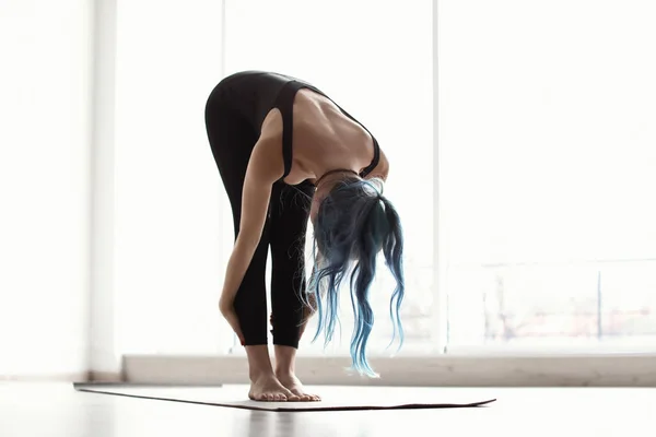 Young woman practicing yoga indoors — Stock Photo, Image