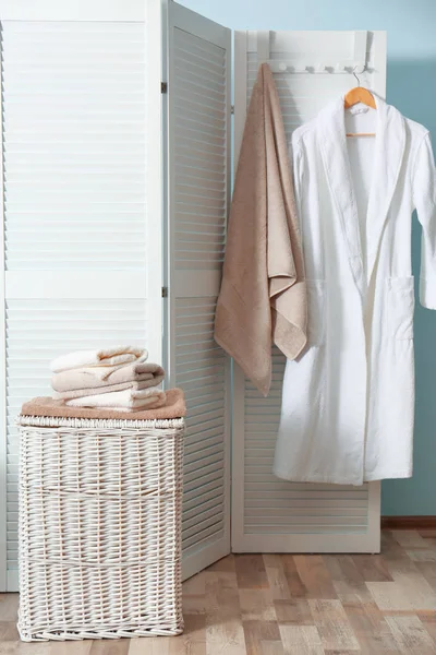 Bathroom interior with laundry basket and soft towels