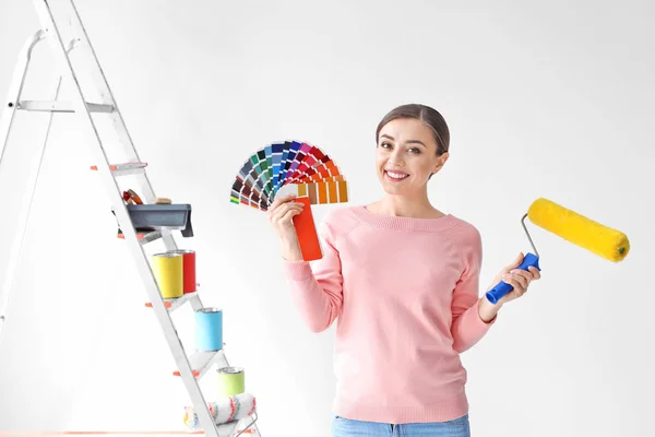 Mladá žena s barevnou paletu na bílém pozadí — Stock fotografie