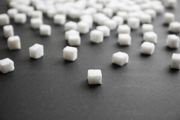 Refined sugar cubes on grey background