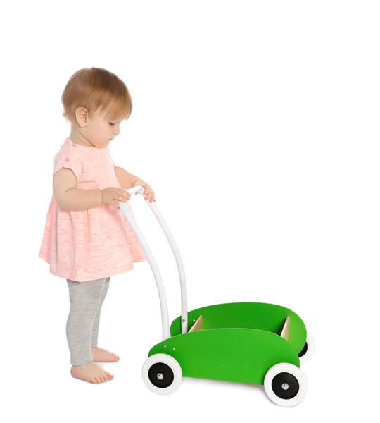 Cute baby playing with toy walker on white background — Stock Photo, Image