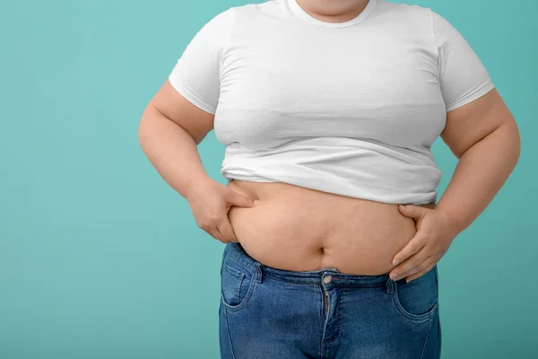 Overweight woman on color background