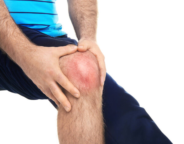 Overweight man suffering from knee pain on white background