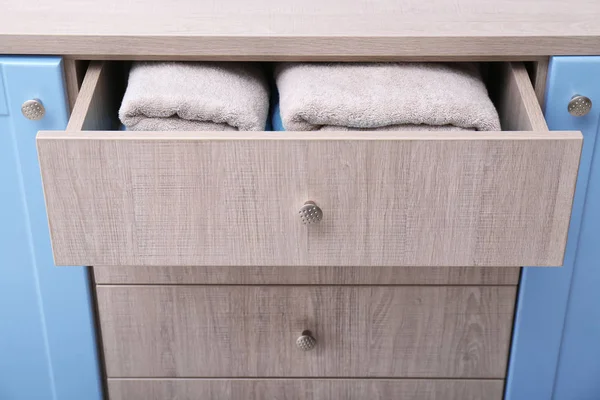Clean towels in open drawer, closeup