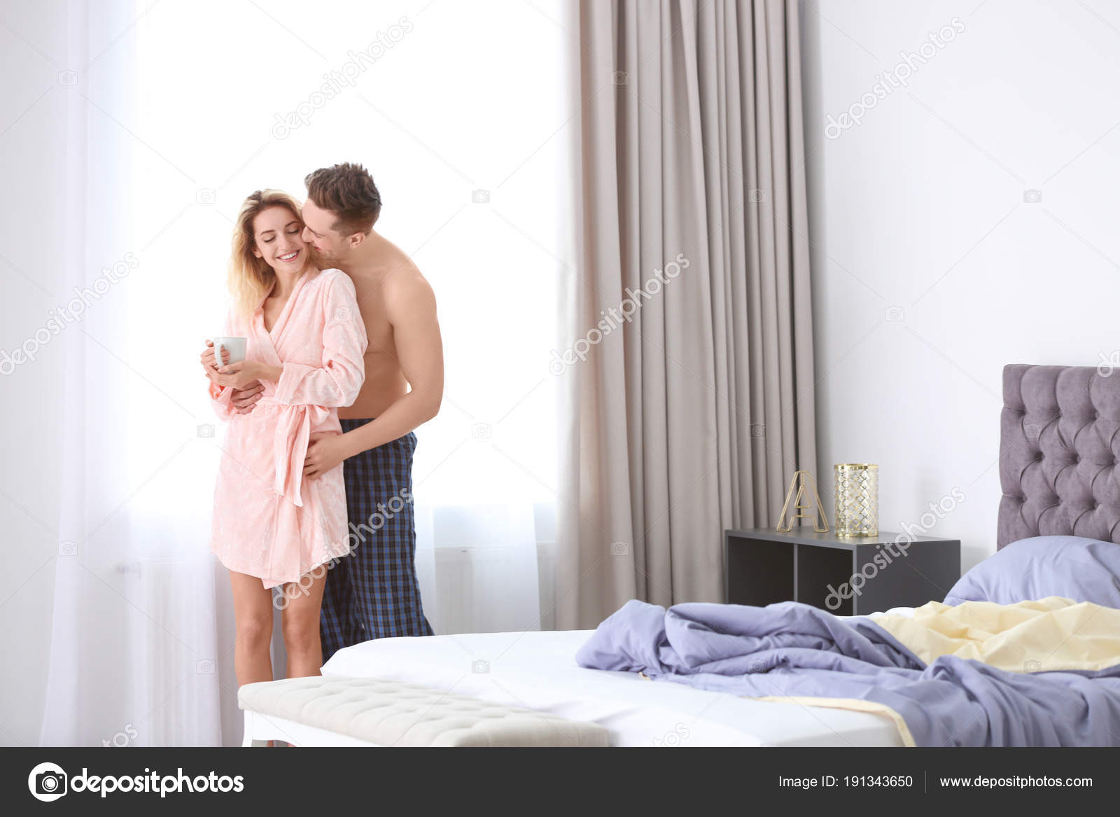 Lovely Young Couple Hugging In Bedroom Stock Photo
