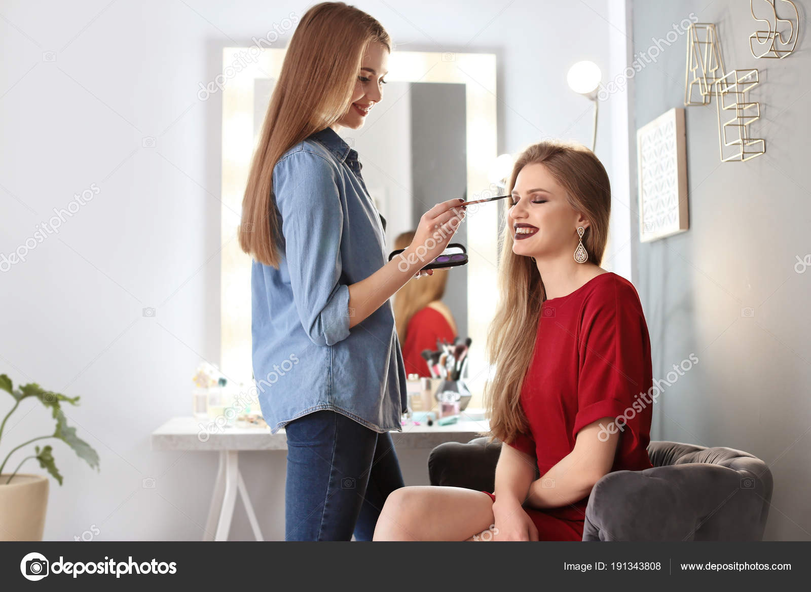 Professional Makeup Artist Working With Beautiful Young Woman In