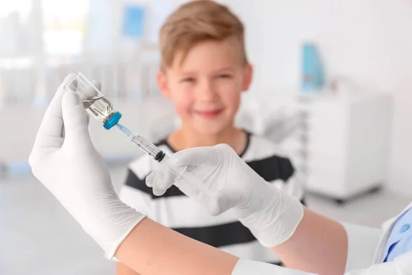 Médecin remplissage seringue avec médicament et enfant sur fond. Journée de vaccination — Photo