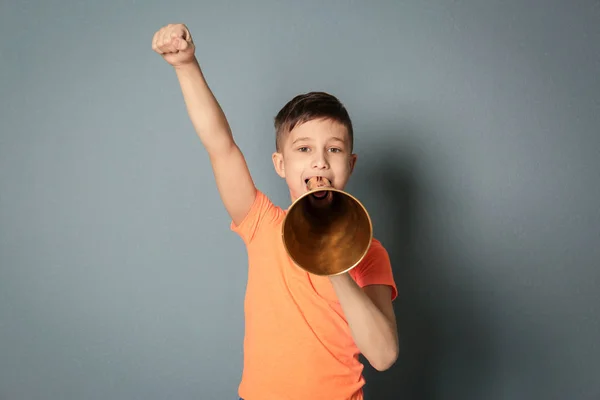 Schattige kleine jongen met megafoon op grijze achtergrond — Stockfoto