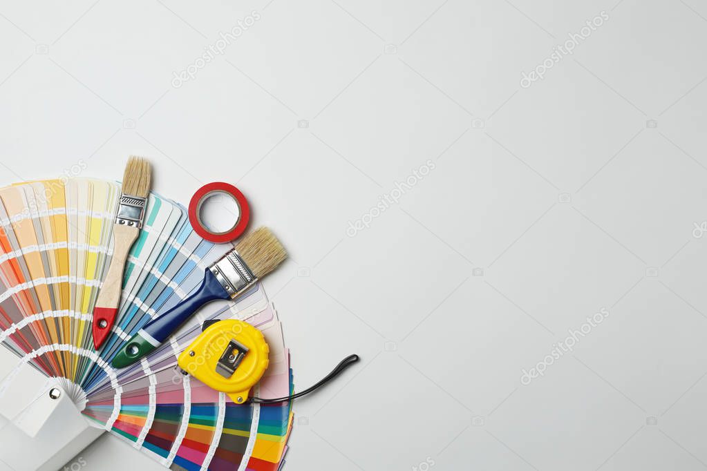 Set of decorator's tools on light background, flat lay