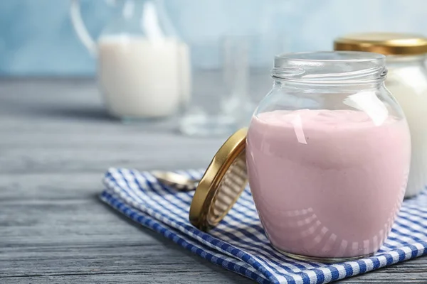 Jar with tasty yogurt on table — Stock Photo, Image