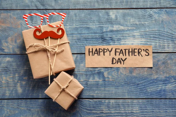 Gift boxes and card with words HAPPY FATHER'S DAY on wooden background, top view — Stock Photo, Image