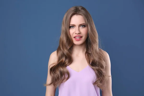 Retrato de mulher jovem com cabelo longo e bonito em fundo de cor — Fotografia de Stock