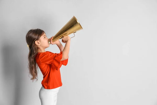 Adorable little girl with vintage megaphone on light background — Stock Photo, Image