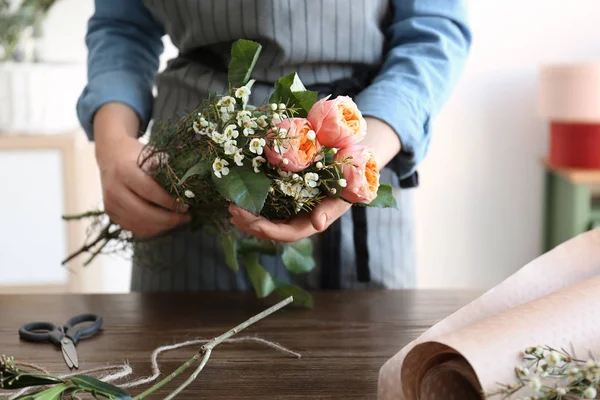 Floristería femenina creando hermoso ramo en la mesa — Foto de Stock