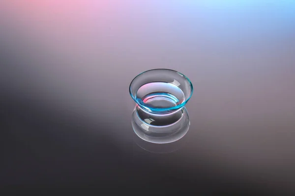 Contact lens on color background