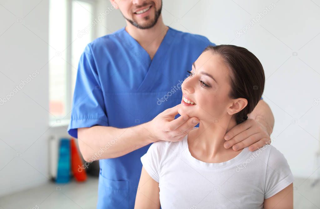 Physiotherapist working with female patient in clinic
