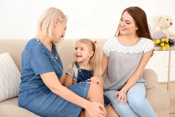 Happy young woman with her mother and daughter at home — Stock Photo, Image