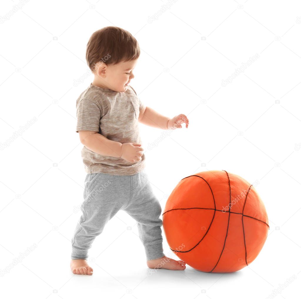 Cute baby playing with ball on white background. Learning to walk